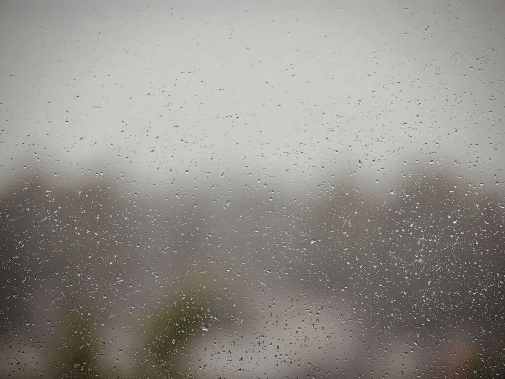 Raindrops and fog on a window obscuring the outdoor view